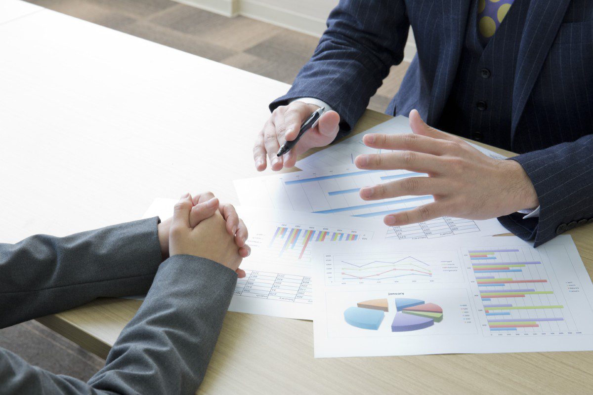 GettyImages-905954160 Business meeting with charts on table.
