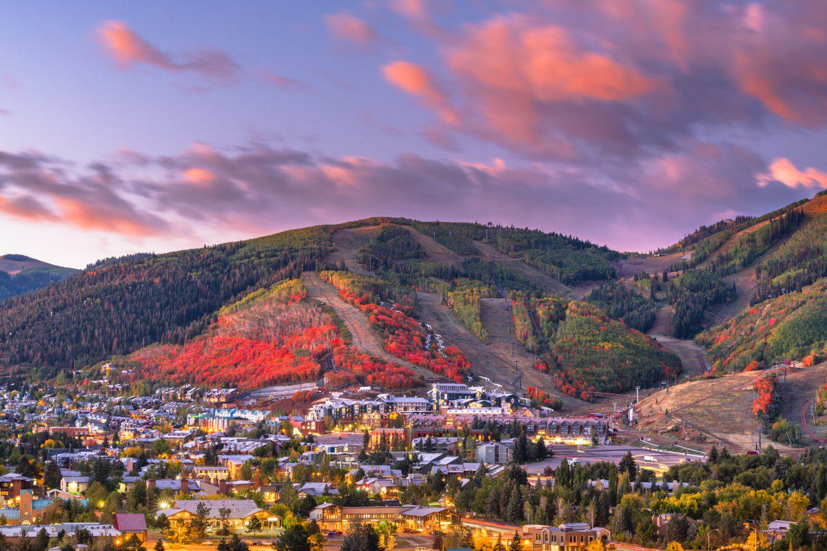 GettyImages-1330083413 Colorful autumn mountain town at sunset.