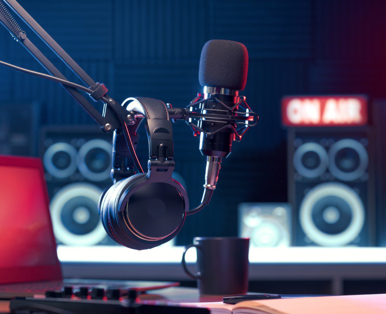 GettyImages-1665390175 Podcast studio setup with microphone and headphones.