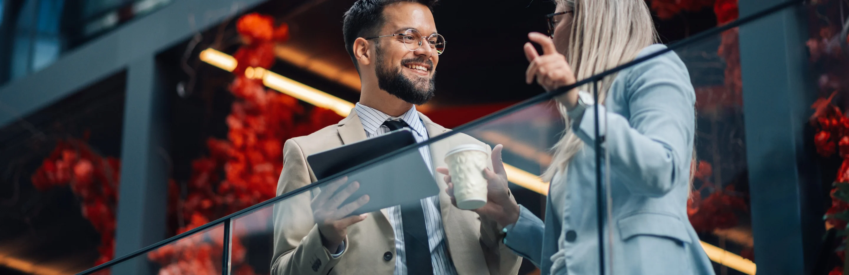 GettyImages-2186861440 (1) Business professionals conversing on modern office balcony.