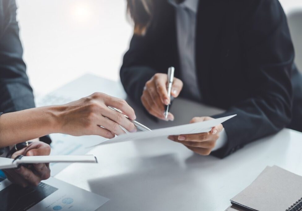 Business meeting with people discussing documents.