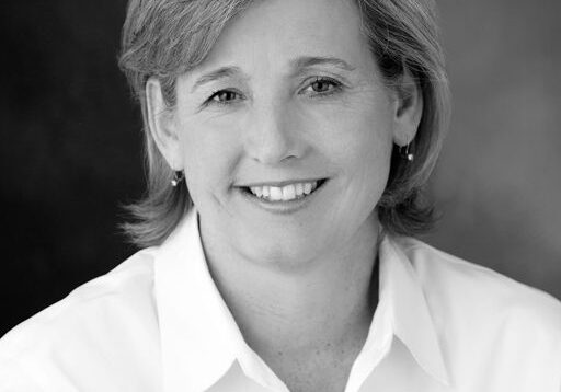 Smiling woman in a white shirt portrait.